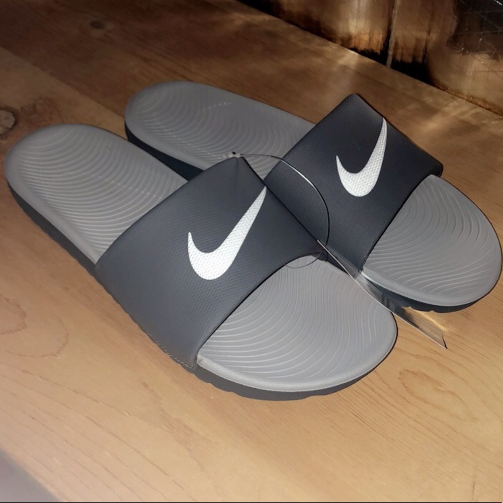 Men’s grey Nike swoosh slides